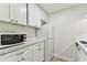 Bright kitchen with white cabinets, and compact appliances maximizing the counter space in a streamlined layout at 36750 Us 19 N # 20311, Palm Harbor, FL 34684
