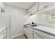 Efficient kitchen with white appliances, ample cabinet space, and view to the entry hallway and living space at 36750 Us 19 N # 20311, Palm Harbor, FL 34684