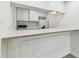 Compact kitchen features a breakfast bar and modern appliances, maximizing functionality in a small footprint at 36750 Us 19 N # 20311, Palm Harbor, FL 34684