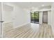 Main bedroom featuring hard wood style flooring, a balcony and natural lighting at 36750 Us 19 N # 20311, Palm Harbor, FL 34684