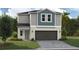 Charming two-story home showcasing a blend of modern design and inviting curb appeal with a two car garage and lovely landscaping at 37225 Sagemoor Dr, Zephyrhills, FL 33541