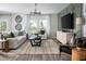 Comfortable living room with modern accents and lots of light and an accent wall at 37225 Sagemoor Dr, Zephyrhills, FL 33541