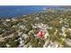 An aerial view showcases the lot's location within a lush, tree-filled neighborhood near the water at 401 Pennsylvania Ave, Crystal Beach, FL 34681