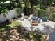 Landscaped backyard features a stone fire pit area, lounge chairs, and well-maintained landscaping at 401 Pennsylvania Ave, Crystal Beach, FL 34681
