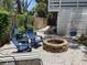 Fire pit and backyard sitting area surrounded by rock ground cover at 401 Pennsylvania Ave, Crystal Beach, FL 34681