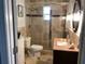 Well-maintained bathroom featuring granite countertops, tiled shower, and ample lighting for a spa-like retreat at 401 Pennsylvania Ave, Crystal Beach, FL 34681