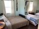 Inviting bedroom with multiple beds, side tables, and decor at 401 Pennsylvania Ave, Crystal Beach, FL 34681