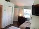 Cozy bedroom with a closet, dresser, and window, providing ample storage and natural light at 401 Pennsylvania Ave, Crystal Beach, FL 34681