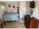 Cozy bedroom featuring a bed, dresser, and plant, creating a relaxing atmosphere at 401 Pennsylvania Ave, Crystal Beach, FL 34681