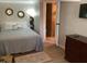 Bedroom featuring mirrors, a bed, an open doorway, and dresser at 401 Pennsylvania Ave, Crystal Beach, FL 34681