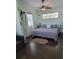 Charming bedroom with a cozy bed, ceiling fan, and a sunny window, offering a relaxing retreat at 401 Pennsylvania Ave, Crystal Beach, FL 34681