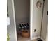 This is a closet with gray walls, tan floors, and a basket of colorful linens at 401 Pennsylvania Ave, Crystal Beach, FL 34681