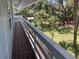 The wooden deck overlooks the lawn and features wooden railings and peaceful views at 401 Pennsylvania Ave, Crystal Beach, FL 34681