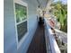Exterior deck on this cottage features wood flooring, white railings, and outdoor seating at 401 Pennsylvania Ave, Crystal Beach, FL 34681
