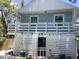 Back exterior view of home with 2nd story deck and landscaped backyard at 401 Pennsylvania Ave, Crystal Beach, FL 34681