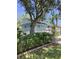 Inviting exterior view with two-story design, lush landscaping, and charming porches, perfect for relaxing outdoors at 401 Pennsylvania Ave, Crystal Beach, FL 34681