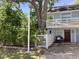 Charming two-story home features a cozy front porch, white picket fence, and landscaped garden for added curb appeal at 401 Pennsylvania Ave, Crystal Beach, FL 34681