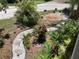 Lush front yard landscaping with winding rock path and diverse planting bed at 401 Pennsylvania Ave, Crystal Beach, FL 34681