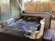Outdoor hot tub with jets running, and a purple light glowing in the water at 401 Pennsylvania Ave, Crystal Beach, FL 34681