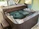 Outdoor hot tub, partially covered, with steps leading to it at 401 Pennsylvania Ave, Crystal Beach, FL 34681
