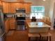 Well-equipped kitchen features stainless steel appliances, custom cabinetry, and an island with stool seating at 401 Pennsylvania Ave, Crystal Beach, FL 34681