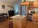 Updated kitchen boasts stainless steel appliances, a kitchen island, and natural light for a welcoming atmosphere at 401 Pennsylvania Ave, Crystal Beach, FL 34681