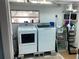 The laundry room features updated appliances and storage shelving for convenience and organization at 401 Pennsylvania Ave, Crystal Beach, FL 34681
