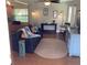Cozy living room with hardwood floors, ceiling fan, and comfortable furnishings at 401 Pennsylvania Ave, Crystal Beach, FL 34681