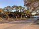 Scenic neighborhood park with mature trees and visible benches creates a welcoming outdoor space for residents at 401 Pennsylvania Ave, Crystal Beach, FL 34681