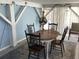 Enjoy outdoor dining on this charming patio complete with rustic table, chairs, and cozy string lights at 401 Pennsylvania Ave, Crystal Beach, FL 34681