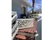 Charming porch seating area with wood deck and decorative white railing at 401 Pennsylvania Ave, Crystal Beach, FL 34681