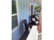 Inviting porch area with comfortable wicker chairs and a view of lush greenery at 401 Pennsylvania Ave, Crystal Beach, FL 34681