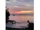 Calm water view at dusk with a distant sailboat, showcasing a peaceful and relaxing atmosphere at 401 Pennsylvania Ave, Crystal Beach, FL 34681