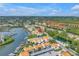 This is an aerial view of a waterfront property with boat docks, lush landscaping, and beautiful waterways at 4202 Harbor House Dr # 24, Tampa, FL 33615