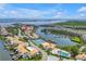 Aerial view showcasing the waterfront community layout, tennis courts, pool, and boat docks at 4202 Harbor House Dr # 24, Tampa, FL 33615