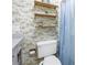 Charming half-bathroom with vanity, flamingo-themed wallpaper, and storage shelf at 4202 Harbor House Dr # 24, Tampa, FL 33615