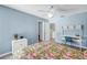 Comfortable bedroom with a flamingo-themed bedding, ceiling fan, and study desk at 4202 Harbor House Dr # 24, Tampa, FL 33615