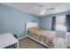 Comfortable bedroom with a flamingo-themed bedding, ceiling fan, and window at 4202 Harbor House Dr # 24, Tampa, FL 33615