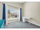 Bright bedroom with a large window, blue curtains, and a modern white desk at 4202 Harbor House Dr # 24, Tampa, FL 33615