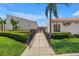 Landscaped entrance to Spinnaker Cove at 4334 featuring a black gated fence at 4202 Harbor House Dr # 24, Tampa, FL 33615