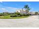 Well-maintained condo exterior with lush landscaping, carport, and beautiful blue skies at 4202 Harbor House Dr # 24, Tampa, FL 33615