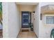 Charming entryway with a blue front door, stone tile floor, and a welcome mat at 4202 Harbor House Dr # 24, Tampa, FL 33615
