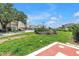 Well-manicured front lawn with mature trees, landscaping, and neighborhood views at 4202 Harbor House Dr # 24, Tampa, FL 33615