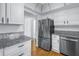 Modern kitchen with stainless steel refrigerator, white cabinets, and granite countertop at 4202 Harbor House Dr # 24, Tampa, FL 33615