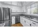 Contemporary kitchen featuring stainless steel appliances, white cabinets, and granite counters at 4202 Harbor House Dr # 24, Tampa, FL 33615