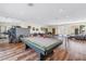 Large recreation room featuring a pool table, ping pong table, and fitness equipment on stylish laminate flooring at 4202 Harbor House Dr # 24, Tampa, FL 33615