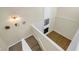 View from above the staircase showcasing the living area and fireplace at 4202 Harbor House Dr # 24, Tampa, FL 33615