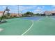 A green and blue tennis court and basketball hoop within the community at 4202 Harbor House Dr # 24, Tampa, FL 33615