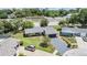 Overhead view of a home showcasing its roof, landscaping, and proximity to neighborhood amenities and other homes at 4228 Belle Isle Ct, New Port Richey, FL 34653