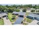 Aerial view of a well-maintained single-story home with lush landscaping, driveway, and proximity to neighborhood amenities at 4228 Belle Isle Ct, New Port Richey, FL 34653